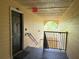Hallway featuring a black door, exit sign and stairwell at 18267 Bridle Club Dr, Tampa, FL 33647