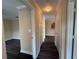 Hallway with wood flooring, access to the kitchen, storage, and other rooms at 18267 Bridle Club Dr, Tampa, FL 33647