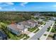 Aerial view of a home on a corner lot, showcasing the backyard and nearby community amenities, including a pond at 18636 Sailors Delight Pass, Land O Lakes, FL 34638