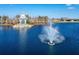 Aerial view of a community lake with a fountain and rainbow in the water at 18636 Sailors Delight Pass, Land O Lakes, FL 34638