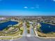 An aerial view showcases the Primary-planned community nestled among beautiful lakes and lush landscapes at 18636 Sailors Delight Pass, Land O Lakes, FL 34638