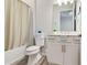 Bright bathroom featuring modern fixtures, tile flooring, and shower with neutral colored curtain at 18636 Sailors Delight Pass, Land O Lakes, FL 34638