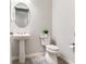 Charming half-bathroom featuring a pedestal sink, modern toilet, and neutral tones, creating a clean and functional space at 18636 Sailors Delight Pass, Land O Lakes, FL 34638