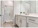 Modern bathroom with a glass-enclosed shower, a white vanity, and brushed nickel fixtures, offering a spa-like experience at 18636 Sailors Delight Pass, Land O Lakes, FL 34638