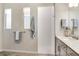 Well-lit bathroom featuring a white tiled walk-in shower and modern vanity at 18636 Sailors Delight Pass, Land O Lakes, FL 34638