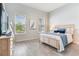 Serene bedroom with light wood furniture, bright windows, and soft blue accents, creating a calming retreat at 18636 Sailors Delight Pass, Land O Lakes, FL 34638
