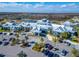 Community clubhouse aerial featuring extensive parking, lush landscaping, and outdoor gathering spaces at 18636 Sailors Delight Pass, Land O Lakes, FL 34638