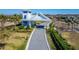 View of community entrance featuring a guard house, gate, meticulous landscaping, and brick-paved road at 18636 Sailors Delight Pass, Land O Lakes, FL 34638