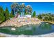 Community entrance signage and landscaping, featuring a stone waterfall feature and lush plants at 18636 Sailors Delight Pass, Land O Lakes, FL 34638