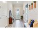 Bright foyer features neutral tile flooring, a stylish console table, bench seating, and decorative accents at 18636 Sailors Delight Pass, Land O Lakes, FL 34638