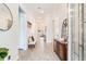 Welcoming foyer with tile floors, neutral paint, a decorative mirror, and furniture for a stylish entrance at 18636 Sailors Delight Pass, Land O Lakes, FL 34638