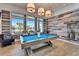 Community game room featuring a billiards table, comfortable seating, and views of the community pool at 18636 Sailors Delight Pass, Land O Lakes, FL 34638