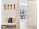 Hallway featuring bench seating with decorative pillows, with a view into a bright office space at 18636 Sailors Delight Pass, Land O Lakes, FL 34638