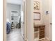 Hallway with built-in storage leading to bedroom, decorated with artwork and a calendar at 18636 Sailors Delight Pass, Land O Lakes, FL 34638