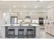 Bright kitchen features a central island with seating, modern appliances, and a tile backsplash at 18636 Sailors Delight Pass, Land O Lakes, FL 34638