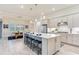 Open kitchen with a large island and barstool seating next to a dining area with modern décor at 18636 Sailors Delight Pass, Land O Lakes, FL 34638