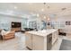 Open-concept kitchen features a large island with stainless steel appliances and seamlessly flows into the living area at 18636 Sailors Delight Pass, Land O Lakes, FL 34638