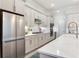 Modern kitchen design with stainless steel appliances, white shaker cabinets, quartz countertops, and subway tile backsplash at 18636 Sailors Delight Pass, Land O Lakes, FL 34638