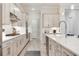 Spacious kitchen featuring stainless steel appliances, shaker style cabinets, tile backsplash, and a large island at 18636 Sailors Delight Pass, Land O Lakes, FL 34638