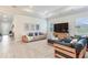 Spacious living room with wood-look tile, modern furnishings, and tray ceiling at 18636 Sailors Delight Pass, Land O Lakes, FL 34638