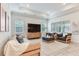 Bright living room with modern furniture, neutral tones, and large windows at 18636 Sailors Delight Pass, Land O Lakes, FL 34638