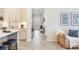 Open-concept living area with tile flooring, neutral decor, and seamless flow from kitchen to living spaces at 18636 Sailors Delight Pass, Land O Lakes, FL 34638