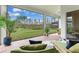 Screened patio with comfortable seating and views of the green backyard and surrounding nature at 18636 Sailors Delight Pass, Land O Lakes, FL 34638