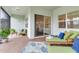 Cozy patio featuring stylish furniture, brick flooring, and sliding glass doors, offering a relaxing outdoor living space at 18636 Sailors Delight Pass, Land O Lakes, FL 34638