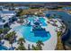 Aerial view of the community pool with swim-up bar, seating, and palm trees at 18636 Sailors Delight Pass, Land O Lakes, FL 34638