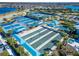 View of community sport courts including tennis and bocce ball, surrounded by greenery and lounge areas at 18636 Sailors Delight Pass, Land O Lakes, FL 34638