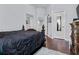 Bedroom showcasing dark wood floors, neutral walls, and a view into another room at 19214 Early Violet Ne Dr, Tampa, FL 33647