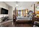 Bedroom featuring hardwood flooring, decorative bed, and neutral walls at 19214 Early Violet Ne Dr, Tampa, FL 33647