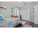 Cozy bedroom with light walls, a plush rug, and a comfortable bed, offering a serene retreat at 19214 Early Violet Ne Dr, Tampa, FL 33647