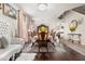 Dining room with hardwood floors, decorative rug, a long dining table and chairs at 19214 Early Violet Ne Dr, Tampa, FL 33647