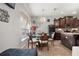 Bright, airy dining area adjacent to the kitchen with large windows and a chandelier for warm lighting at 19214 Early Violet Ne Dr, Tampa, FL 33647