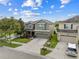 Attractive two-story home with a well-manicured lawn, mature trees, and a spacious driveway in a suburban neighborhood at 19214 Early Violet Ne Dr, Tampa, FL 33647