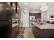 Kitchen features granite countertops, stainless steel appliances, dark wood cabinets, and a mosaic tile backsplash at 19214 Early Violet Ne Dr, Tampa, FL 33647