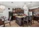 Open-concept kitchen featuring a granite island with seating, dark wood cabinets, and stainless steel appliances at 19214 Early Violet Ne Dr, Tampa, FL 33647
