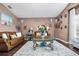 Inviting living room featuring a plush rug, leather couches, and decorative lighting at 19214 Early Violet Ne Dr, Tampa, FL 33647