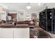 Spacious living room with an elegant chandelier, a large comfy couch, and an archway into the dining room at 19214 Early Violet Ne Dr, Tampa, FL 33647