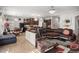 Open-concept living area flows seamlessly into the kitchen, featuring tile flooring, and stylish furnishings at 19214 Early Violet Ne Dr, Tampa, FL 33647