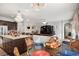 Open-concept kitchen and living area featuring a granite island, dark wood cabinets, and stainless steel appliances at 19214 Early Violet Ne Dr, Tampa, FL 33647