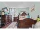 Warmly decorated main bedroom suite with beautiful furniture, a plush rug, and hardwood flooring at 19214 Early Violet Ne Dr, Tampa, FL 33647