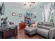This comfortable and functional office space has a ceiling fan, desk, sofa, and ample space for working at 19214 Early Violet Ne Dr, Tampa, FL 33647