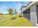 Manicured backyard with lush green grass and pond at 1967 Hovenweep Rd, Wesley Chapel, FL 33543