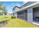 Screened-in patio offers a view of the lush backyard, creating a perfect spot for relaxation and outdoor dining at 1967 Hovenweep Rd, Wesley Chapel, FL 33543