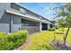 Well-maintained backyard with green grass, landscaping, and screened in porch at 1967 Hovenweep Rd, Wesley Chapel, FL 33543