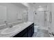 Modern bathroom featuring a double vanity with granite countertops and a glass-enclosed shower at 1967 Hovenweep Rd, Wesley Chapel, FL 33543