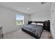 Bright bedroom featuring a large window with a view and a bed with built-in storage at 1967 Hovenweep Rd, Wesley Chapel, FL 33543