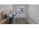 Bedroom featuring a patterned bedspread and natural light at 1967 Hovenweep Rd, Wesley Chapel, FL 33543